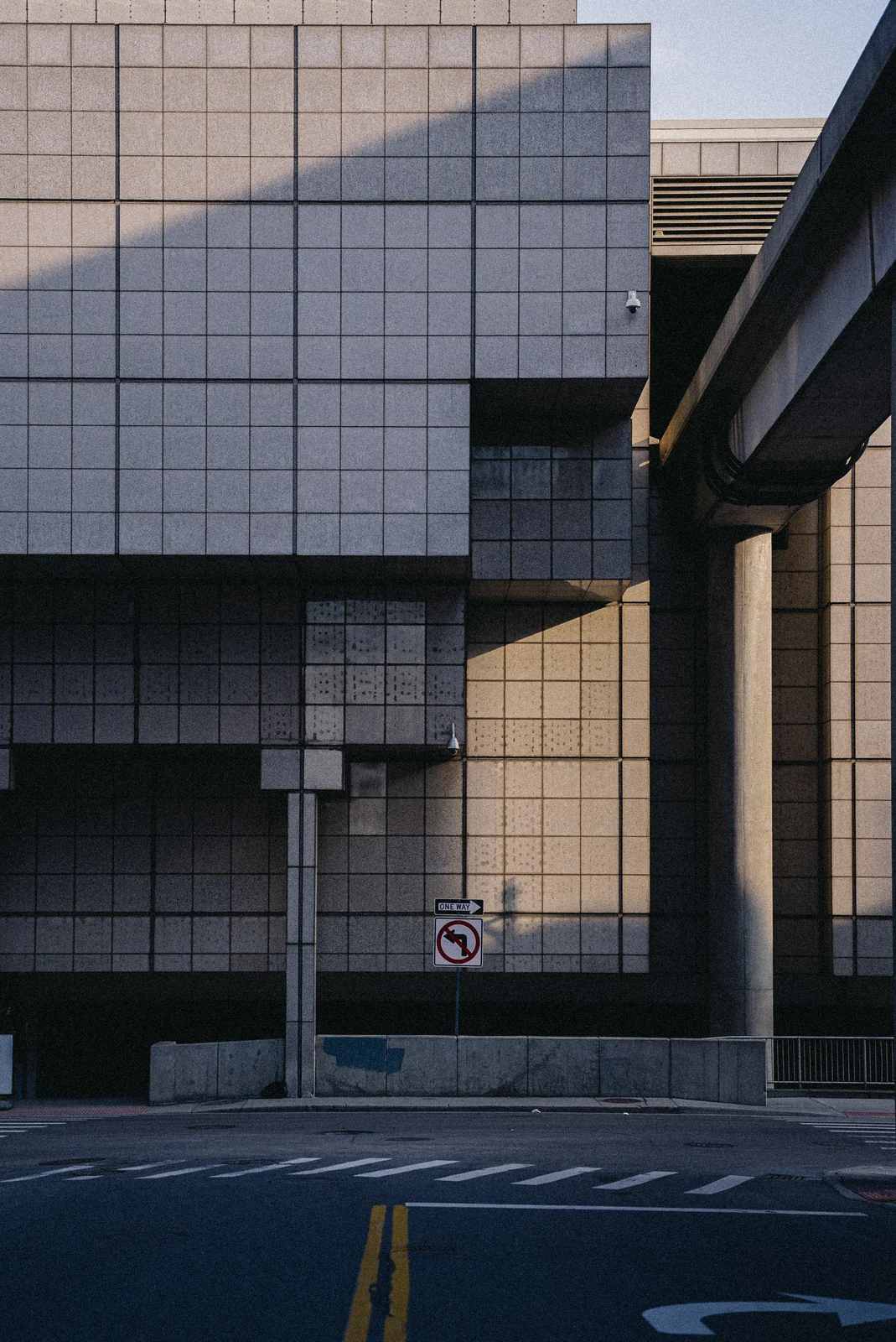A tiled office block and an elevated roadway above an empty street, graded with GX-05 Modernity