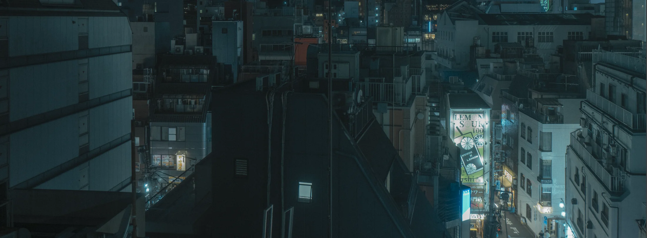 Rooftop air-conditioning units above a lit night city, graded with GX-06 HVACpunk